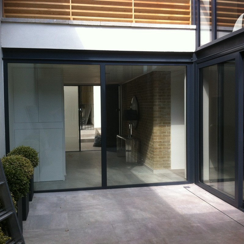 Floor-to-ceiling sliding doors opening to courtyard in Deptford